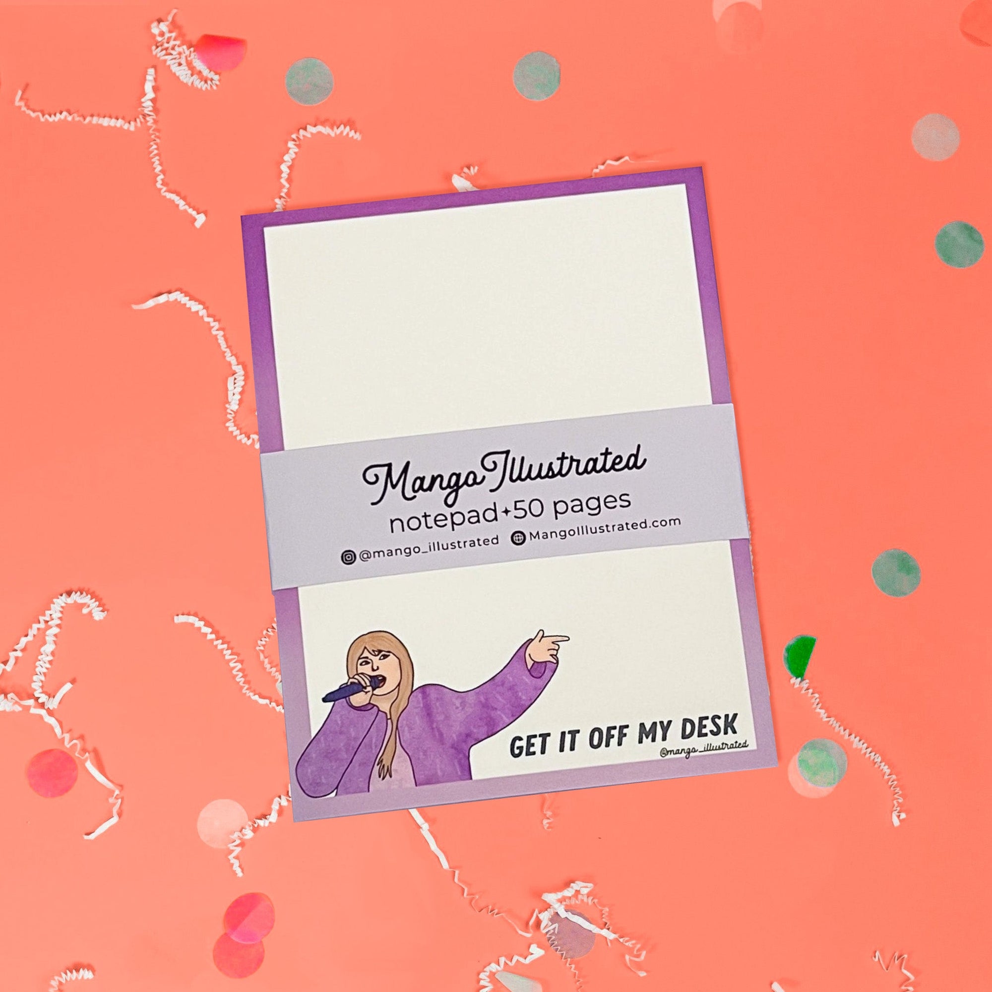 On a coral pink background sits a notepad with white crinkle and big, colorful confetti scattered around. This Taylor Swift inspired notepad is in purple shades with a white background and it says at the top "GET IT OFF MY DESK" in black lettering and there is an illustration of Taylor Swift at the bottom.