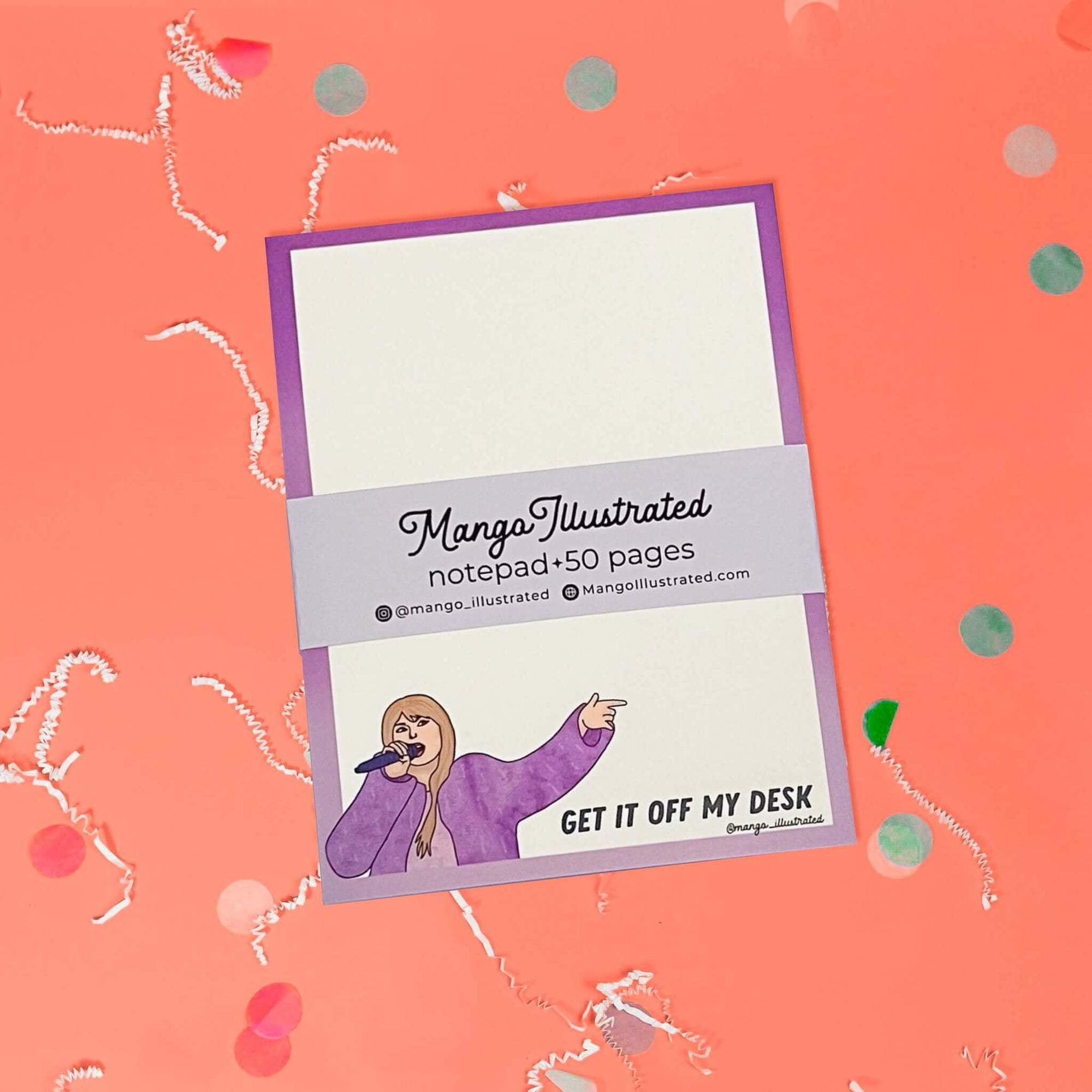 On a coral pink background sits a notepad with white crinkle and big, colorful confetti scattered around. This Taylor Swift inspired notepad is in purple shades with a white background and it says at the top "GET IT OFF MY DESK" in black lettering and there is an illustration of Taylor Swift at the bottom.