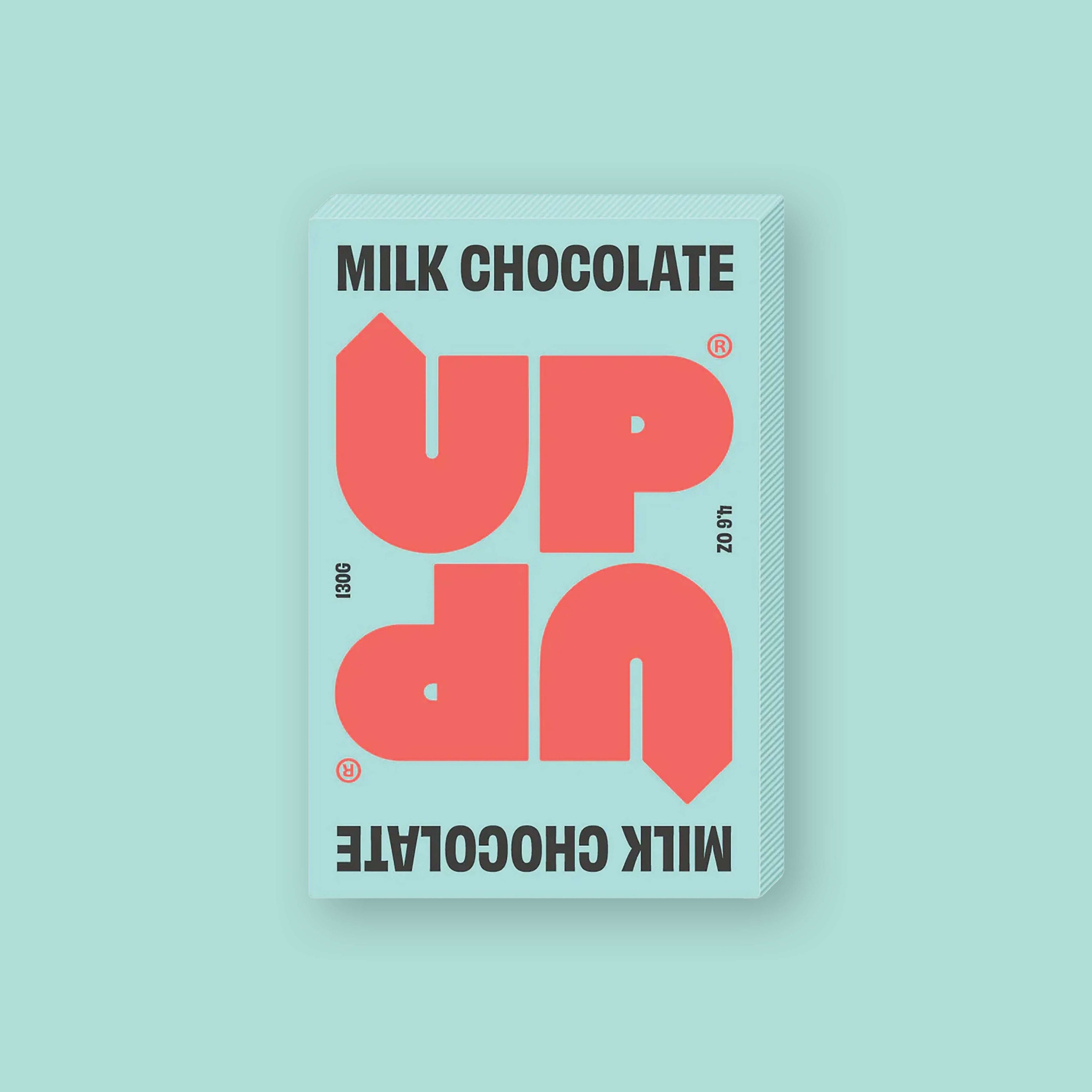 On a mint green background sits a box of UP UP Milk Chocolate. The packaging is in mint green and orangey-red. 130G 4.6 OZ
