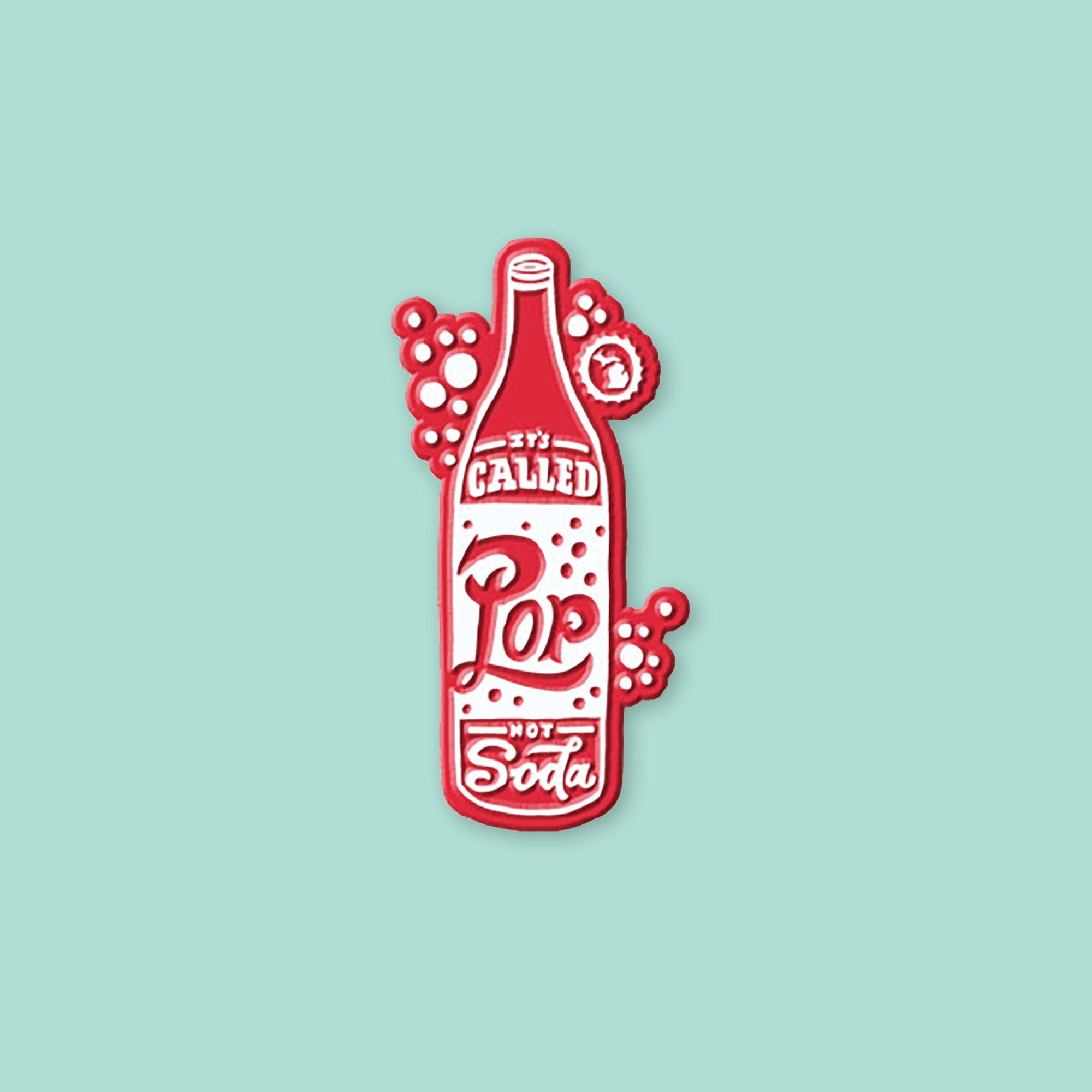 On a mint green background sits a magnet. This 2D-style raised magnet is a red and white handdrawn soda pop that says "It's Called Pop Not Soda" in red and white handwritten lettering. It has a white outline bubble with the state of Michigan in it in white. 3"- 4"