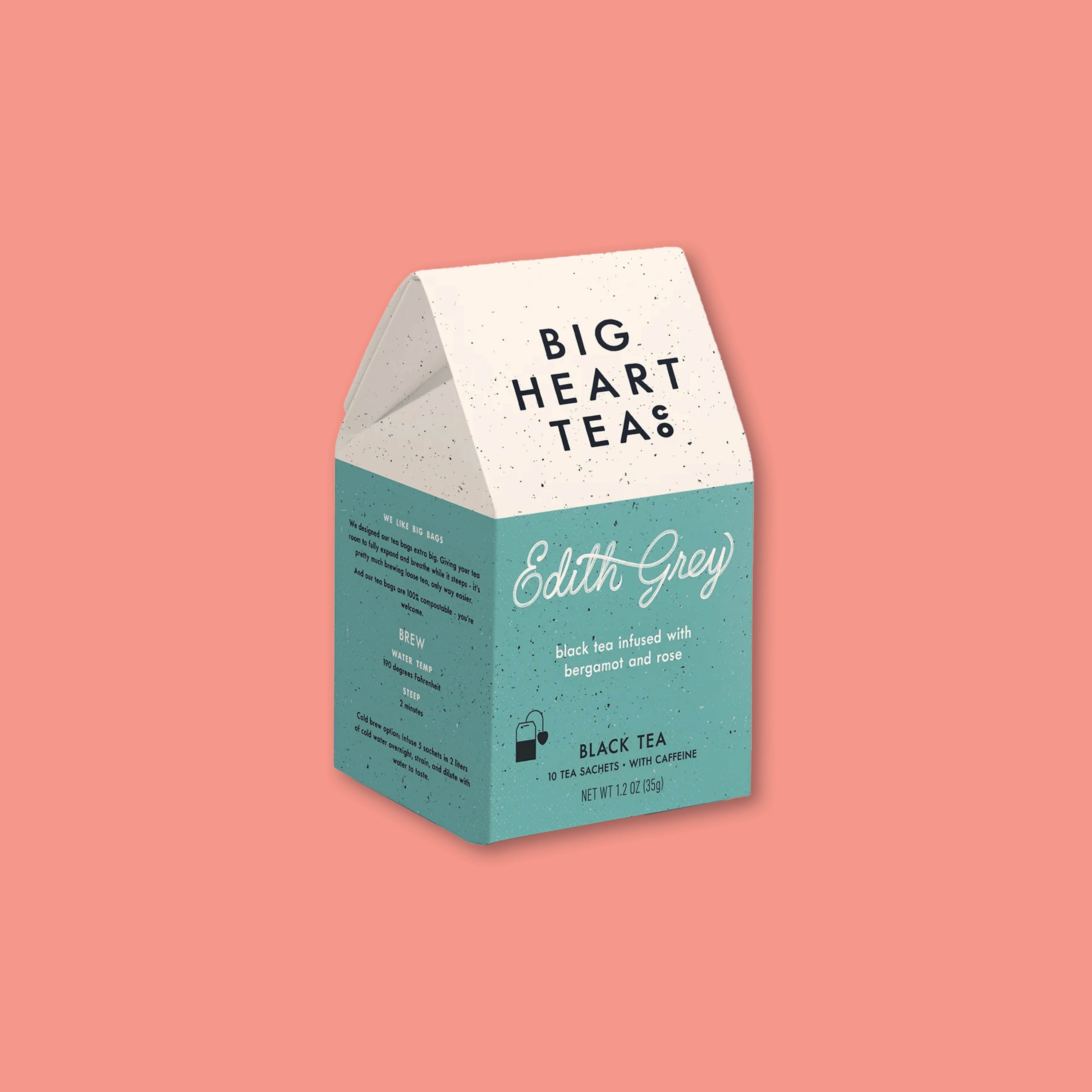 On a coral background sits a teal and white box of Edith Grey tea from Big Heart Tea with 2 sachets.