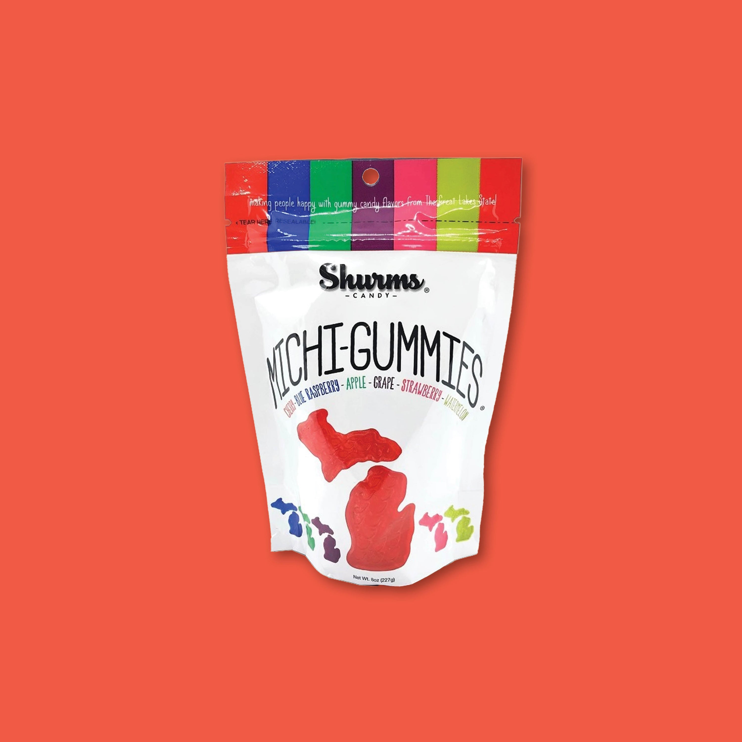On a tomato red background sits an 8 oz. white and rainbow colored pouch of Michi-gummies from Shurms Candy.