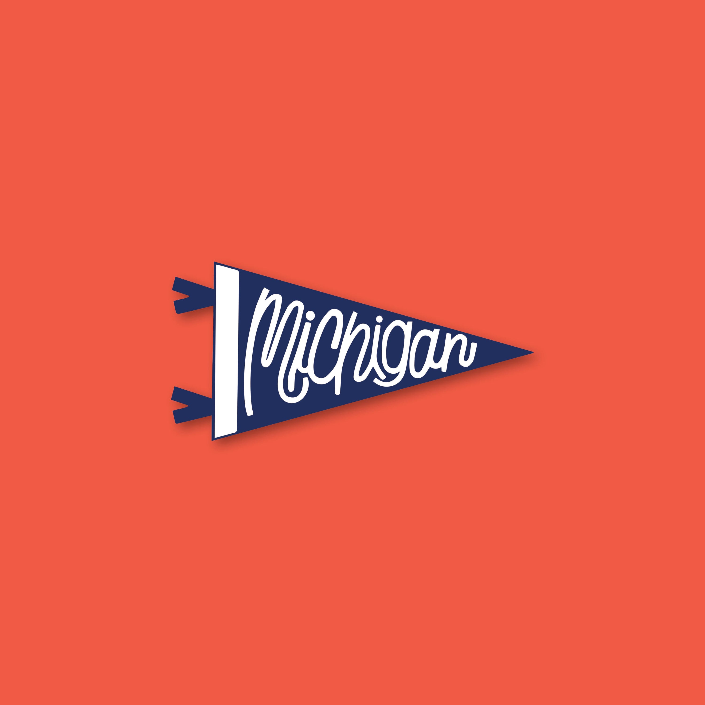 On a tomato red background sits a small blue pennant shape sticker that says Michigan in white script writing.