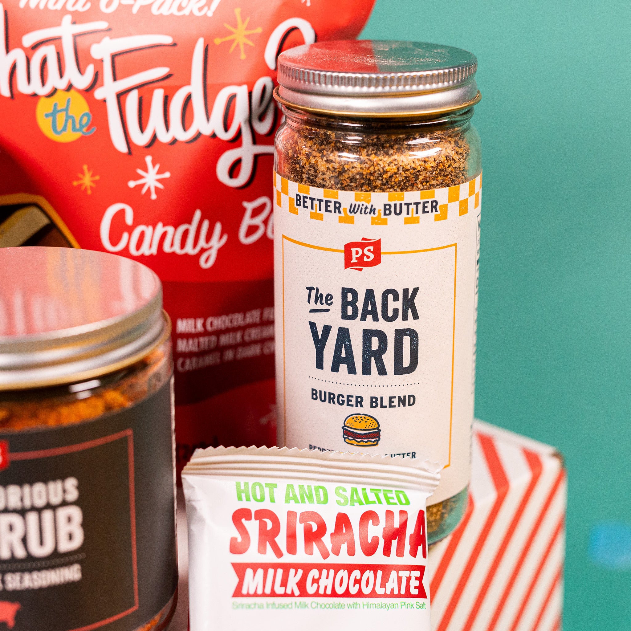 On a teal background sits a jar of The Back Yard Burger Blend seasoning with a white label.