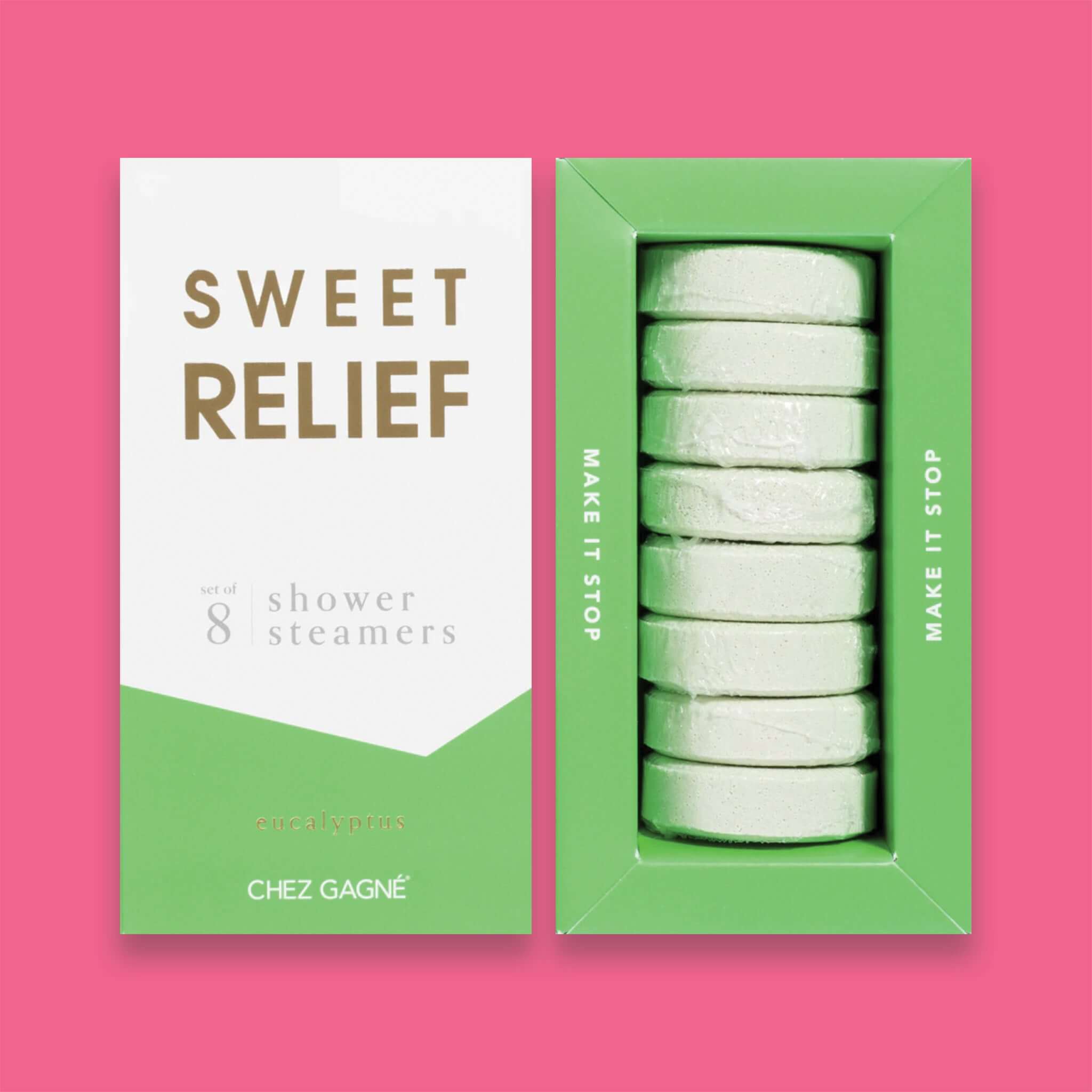 On a hot pink background sits two boxes. This picture is a close-up of a white and lime green package that says "SWEET RELIEF" in gold foil, all caps block lettering. Under it says "set of 8" and " shower steamers" in grey, lowercase serif font. At the bottom it says "eucalyptus" in gold foil, lower case serif font. To the right of it is a lime green box with white shower steamers in it.