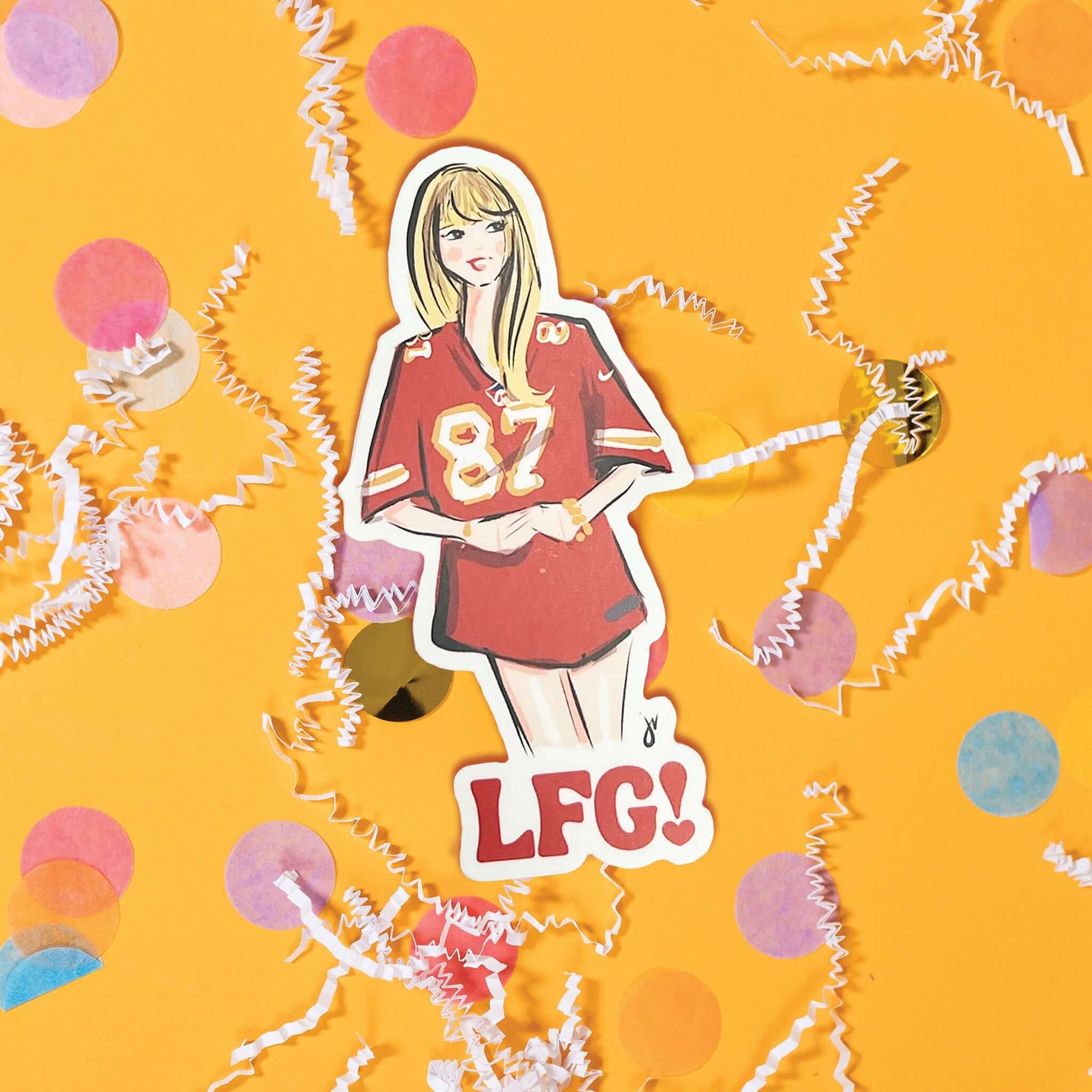 On a sunny mustard background sits a sticker with white crinkle and big, colorful confetti scattered around. This Taylor Swift inspired sticker is an illustration of Taylor Swift wearing a Kansa City Chiefs jersey with the number 87 on it.