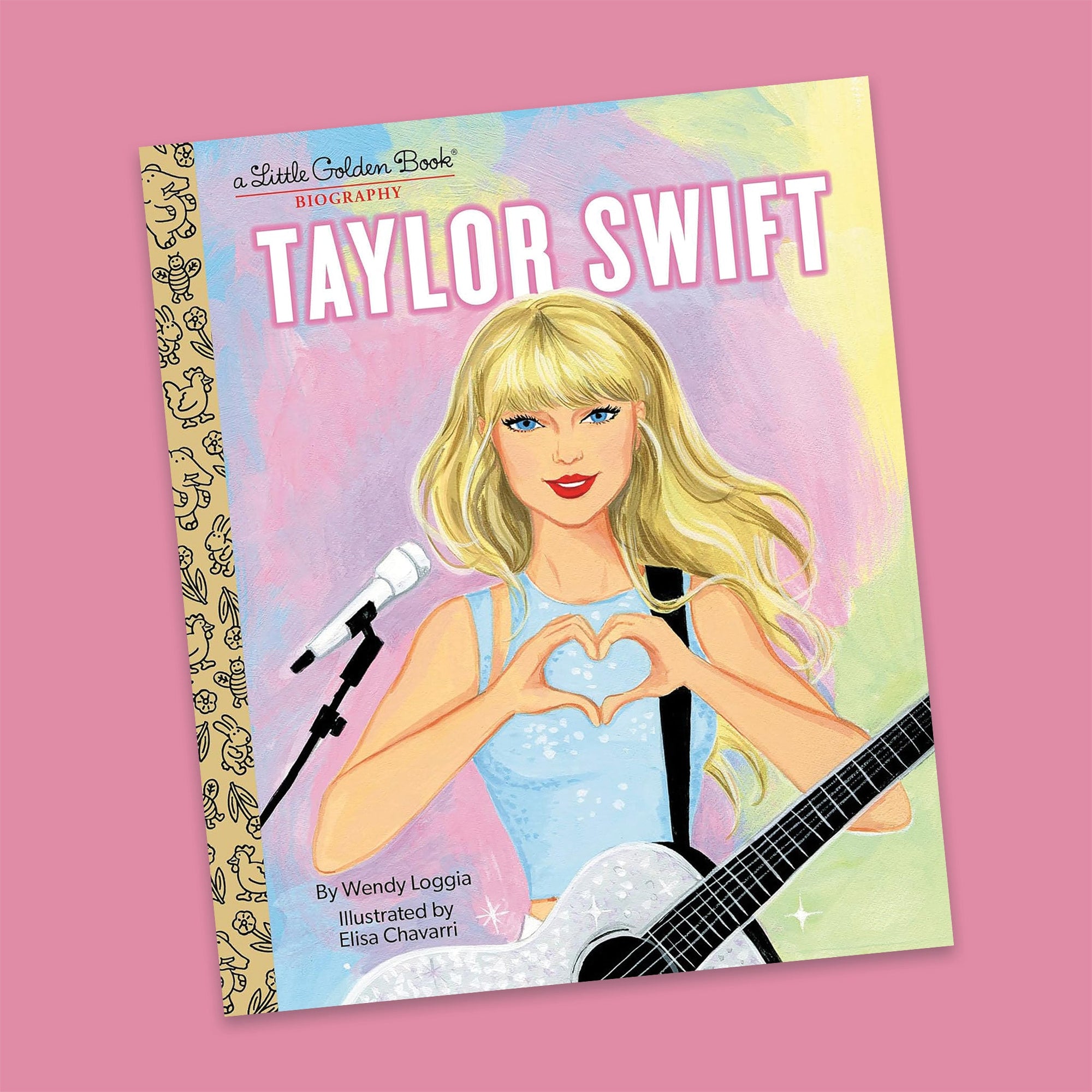 On a bubblegum pink background sits a book. This colorful, Taylor Swift inspired biography by A Little Golden Book is a painting of Taylor Swift holding a silver glitter guitar around her neck and she is using her hands to show a heart. There are painted pastel colors of  blue, pink, purple, green, and yellow. It says "TAYLOR SWIFT" in white, all caps block font with a bubblegum pink outline.