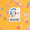 On a sunny mustard background sits a sticker with colorful confetti and white crinkle scattered around. This vintage sticker has an illustration of a darling white kitten staring at itself in a mirror. It says "Been that bitch Still that bitch" in black, thick serif font. Approximately 3".