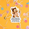 On a sunny mustard background sits a sticker with colorful confetti and white crinkle scattered around. This vintage sticker has an illustration of a cute brown bear wearing a red and cream plaid dress with a blue butterfly on the nose. It says "Once I defeat the chemical imbalance in my brain, it's over for you hoes" in black, thick serif font. Approximately 3".