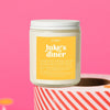 On a hot pink background sits a candle on a red and white packing tape with colorful confetti and white crinkle scattered around. It is has a sunny mustard label with white text. This Luke's Diner Candle has notes of pancakes, maple syrup and vanilla & is the perfect scent for your die hard Gilmore Girl. Candle is 8 oz and burns 35 hours.