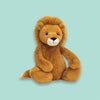 On a mint green background sits a stuffed animal. This golden brown lion is soft and cuddly.
