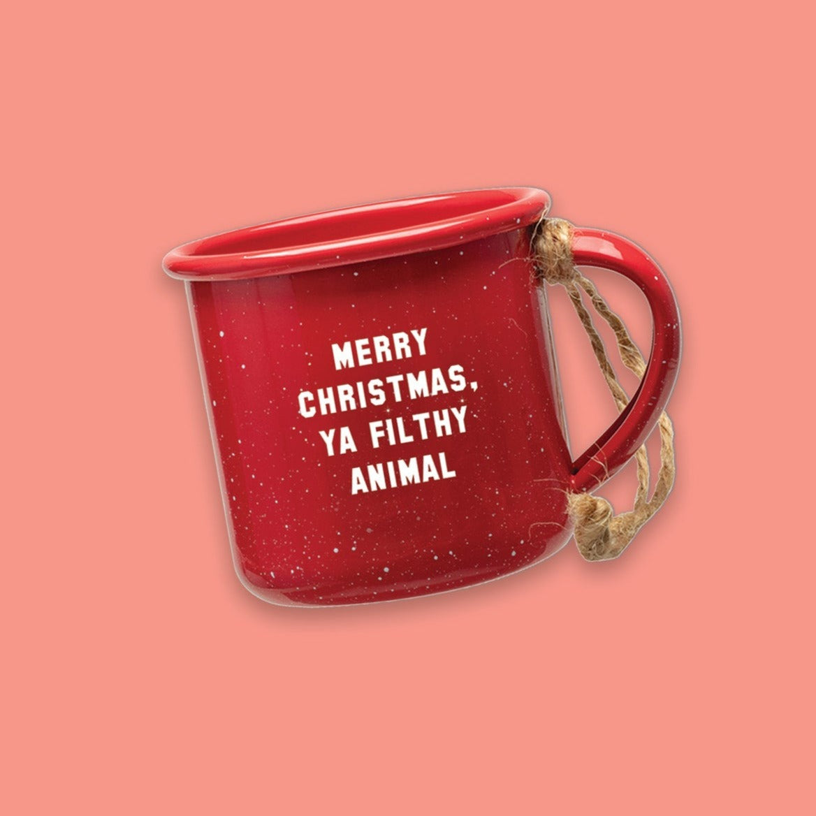 On a coral pink background sits a red mini campfire mug with white specks. It says "MERRY CHRISTMAS, YA FILTHY ANIMAL" in white collegiate lettering. It has twine on the handle.