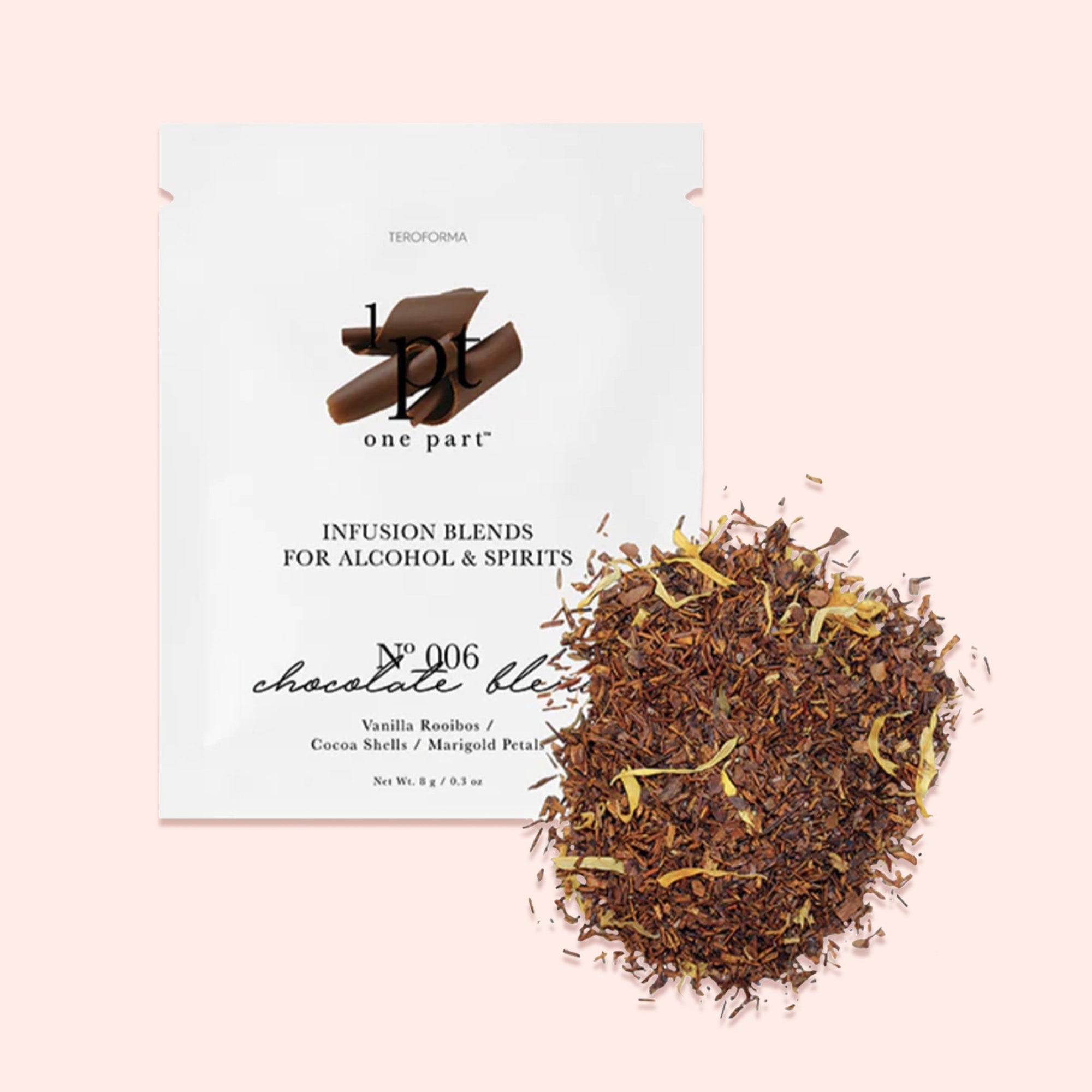 On a light pink background sits a white packet. This One Part Co. single use packet has a picture of chocolate shavings. It says "INFUSION BLENDS FOR ALCOHOL & SPIRITS" in black, all caps serif font. It is a No 006 'chocolate blend' with flavors of 'Vanilla Rooibos / Cocoa Shells / Marigold Petals'. It has seasoning contents of the packet scattered on the right side. Net Wt. 8g / 9.3oz