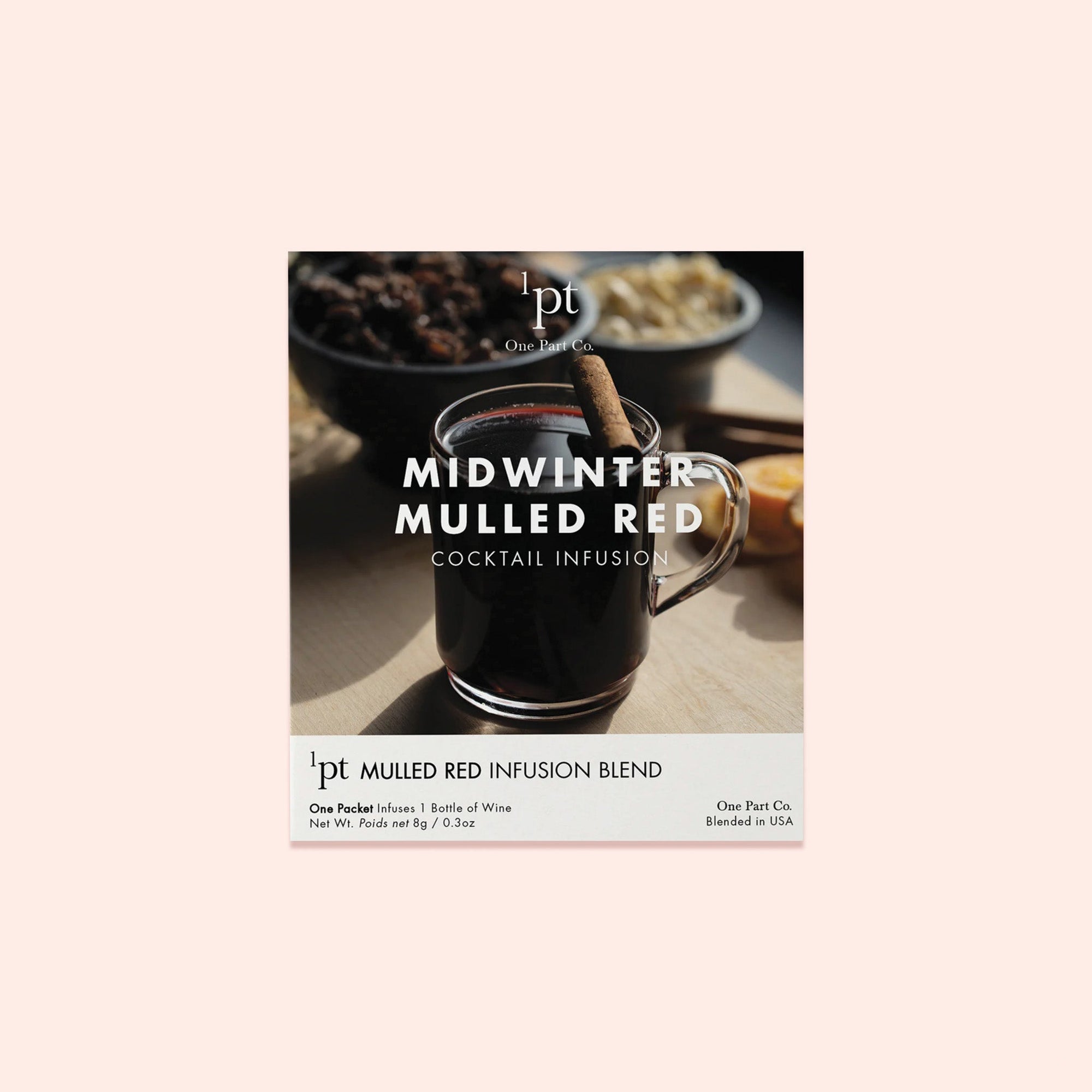 On a light pink background sits a packet with a photo of a Mulled Wine in a glass with a cinnamon stick garnish. It is a 'MIDWINTER MULLED RED COCKTAIL INFUSION' from One Part Co. One Packet infuses 1 Bottle of Wine. Net Wt. 8g / 0.3oz. 