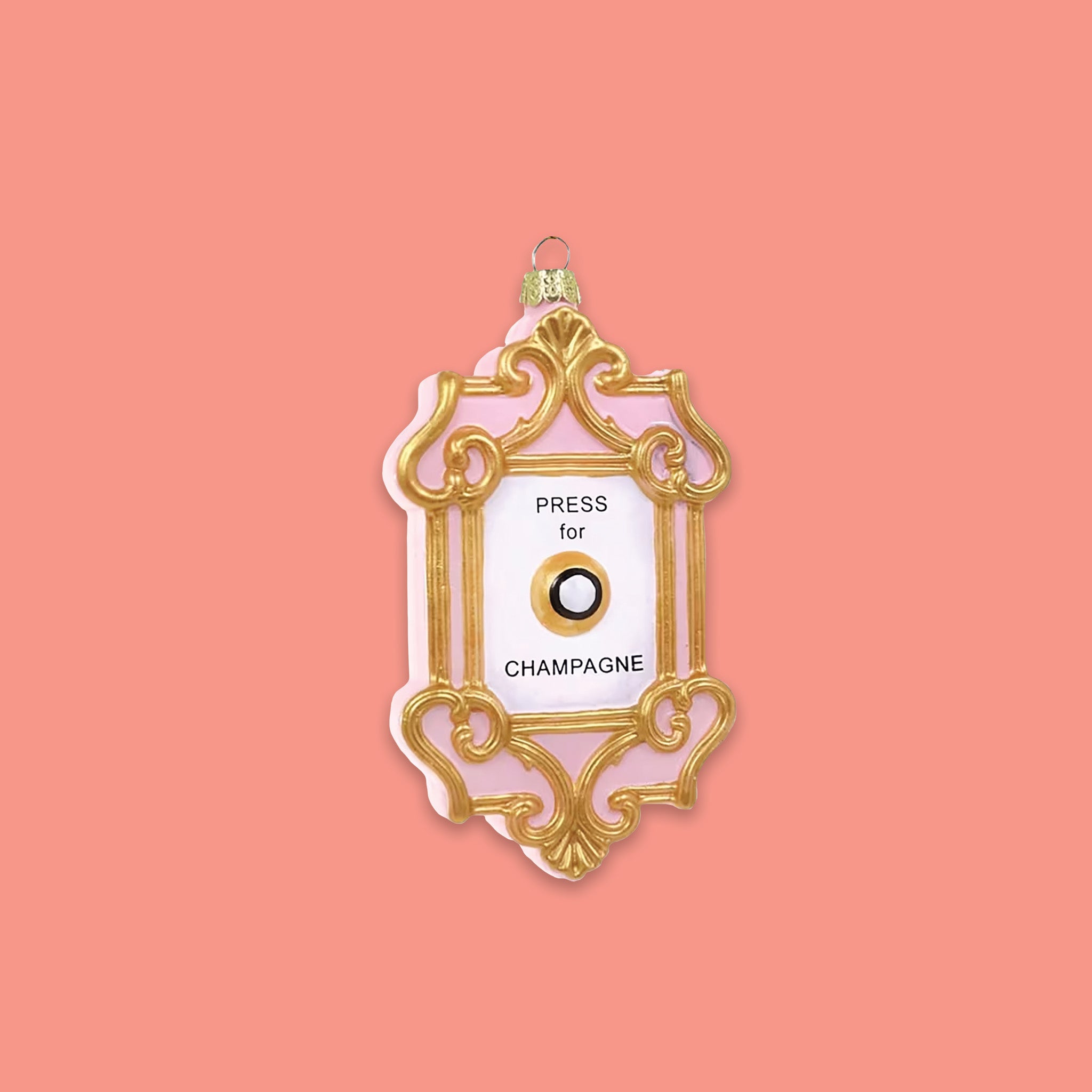 On a coral pink background sits a gold and pink ornament with white in the middle and there is a 'button'. It says "PRESS for CHAMPAGNE" in black.