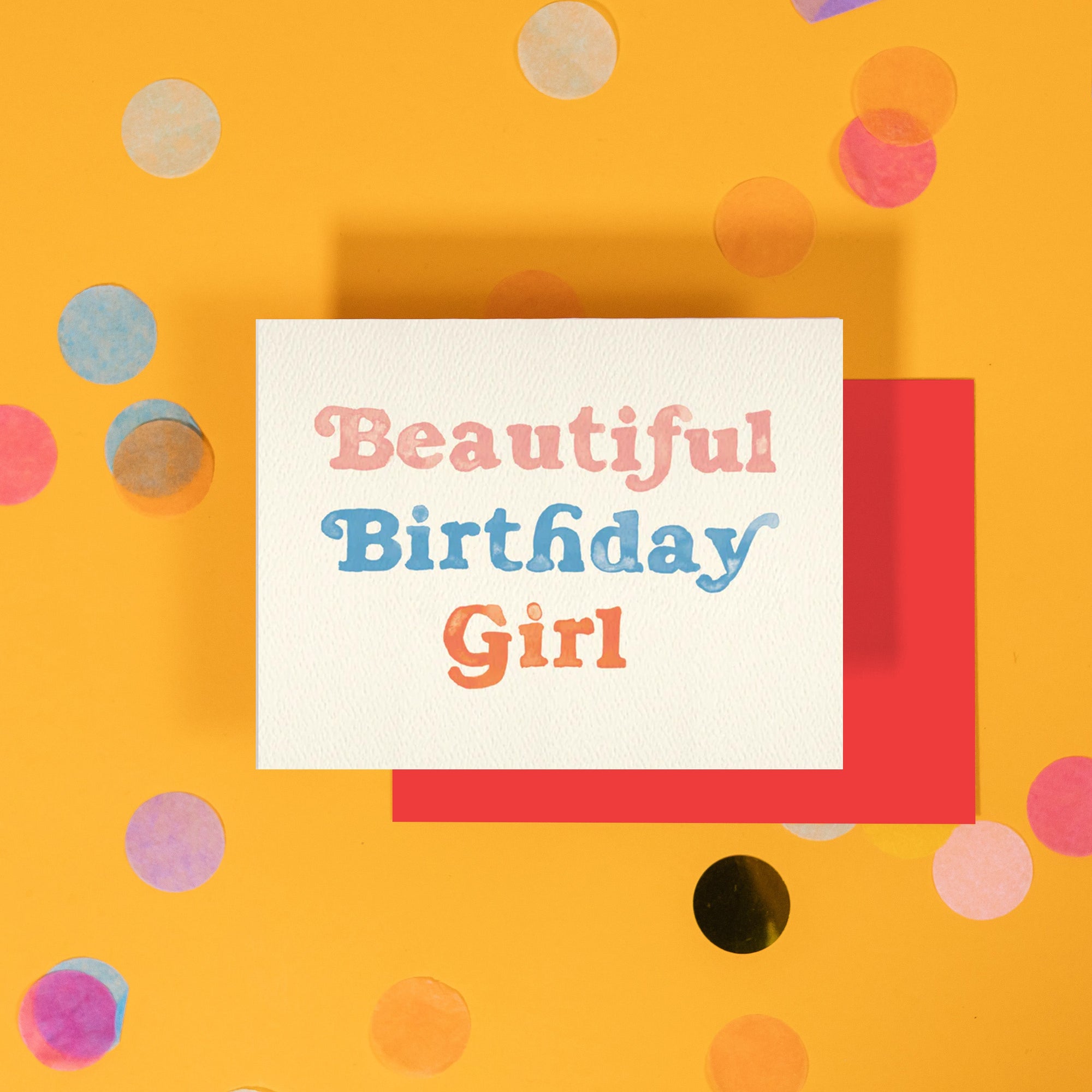 On a bright yellow background with colorful confetti sits a birthday card that reads "Beautiful Birthday Girl" painted with watercolors.