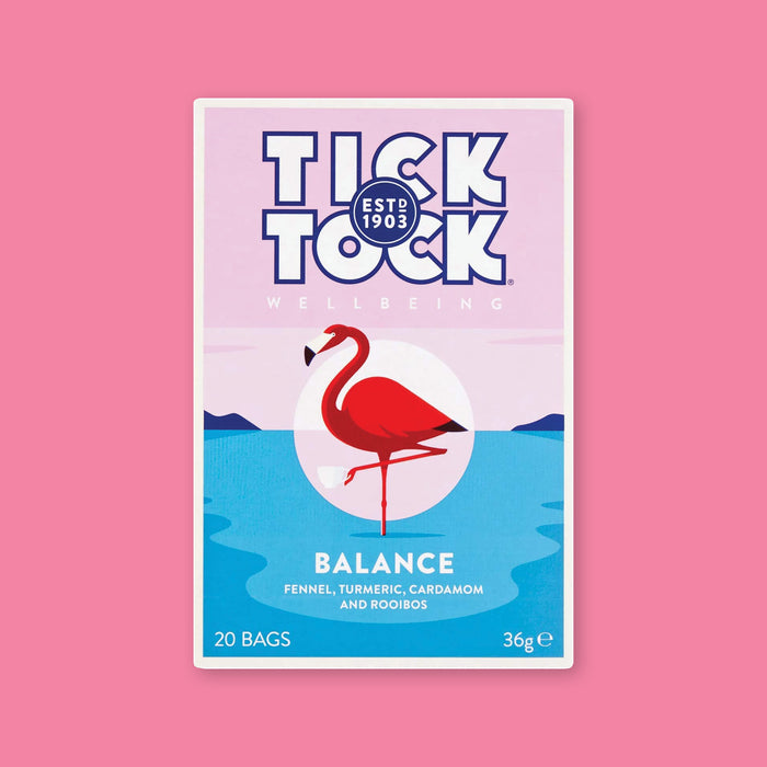 On a bubblegum pink background is a box of tea.The tea is Tick Tock Balance with blends of fennel, turmeric, cinnamon and rooibos. It is naturally caffeine free. It has an illustration of a flamingo standing on one leg. 