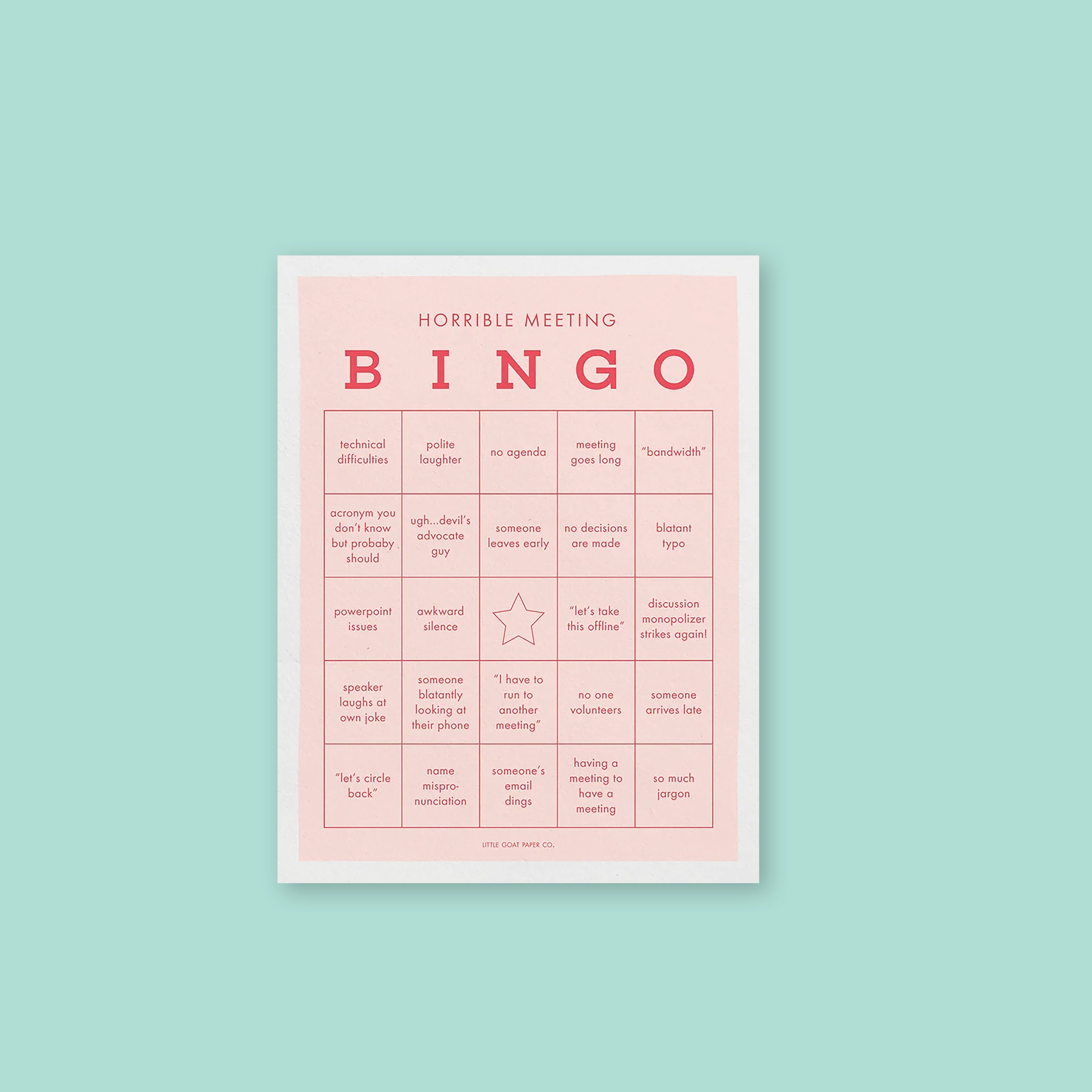 On a mint green background sits a light pink with white border bingo notepad. It is a HORRIBLE MEETING BINGO game with different work-related sayings in red lettering. Some of the sayings are "technical difficulties," "powerpoint issues," "meeting goes long," "someone arrives late," and "having a meeing to have a meeting." 