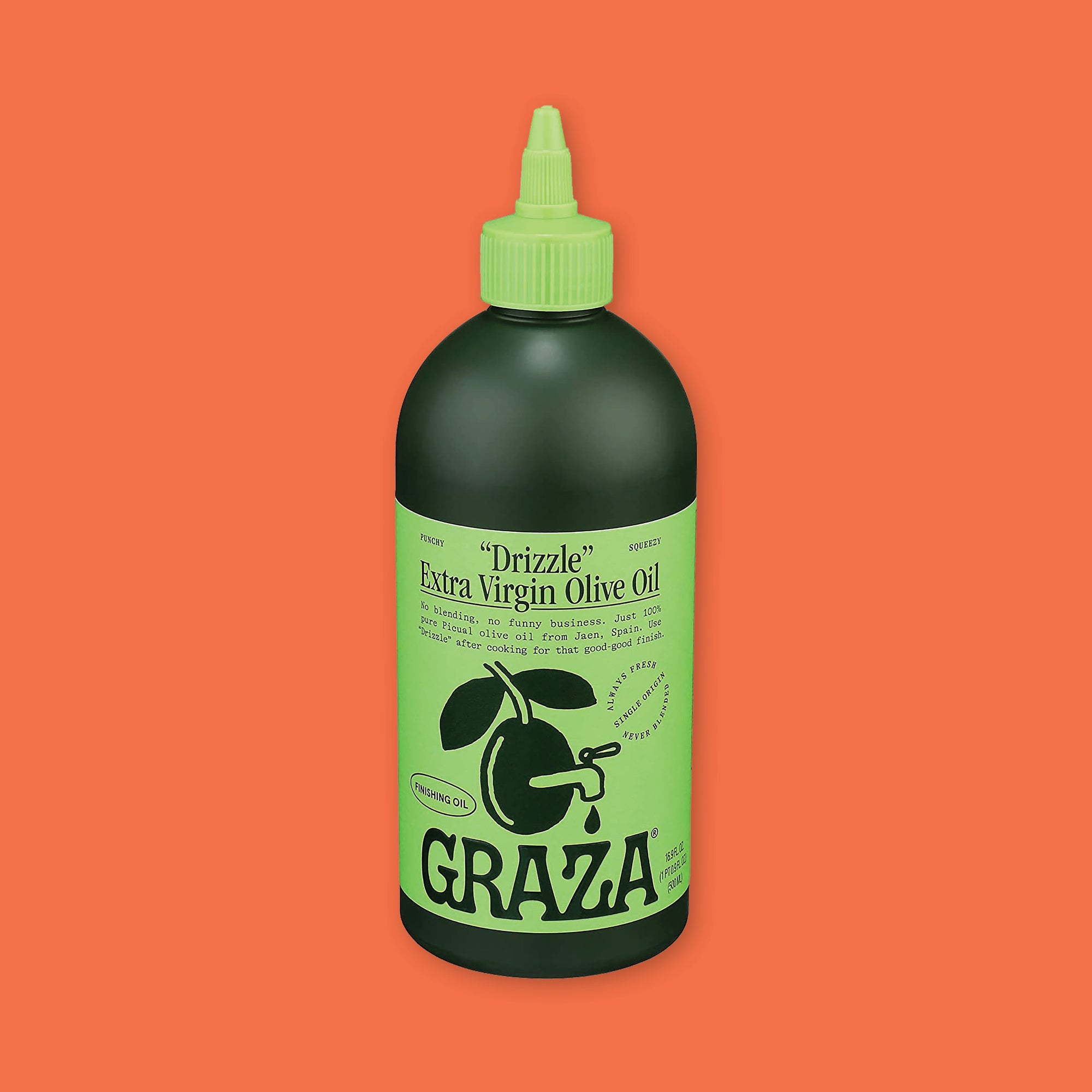 On an orangey-red background sits a bottle. This dark green bottle has a lime green cap and label. It says ""Drizzle" Extra Virgin Olive Oil" in black, serif font. It is "PUNCHY" AND "SQUEEZY". It has an illustration of an olive branch with a spout on the olive in black. It says "ALWAYS FRESH NEVER BLENDED SINGLE ORIGIN" and "FINISHING OIL" and "GRAZA" at the bottom in black, handwritten lettering. 16.9 fl oz (500 ml)