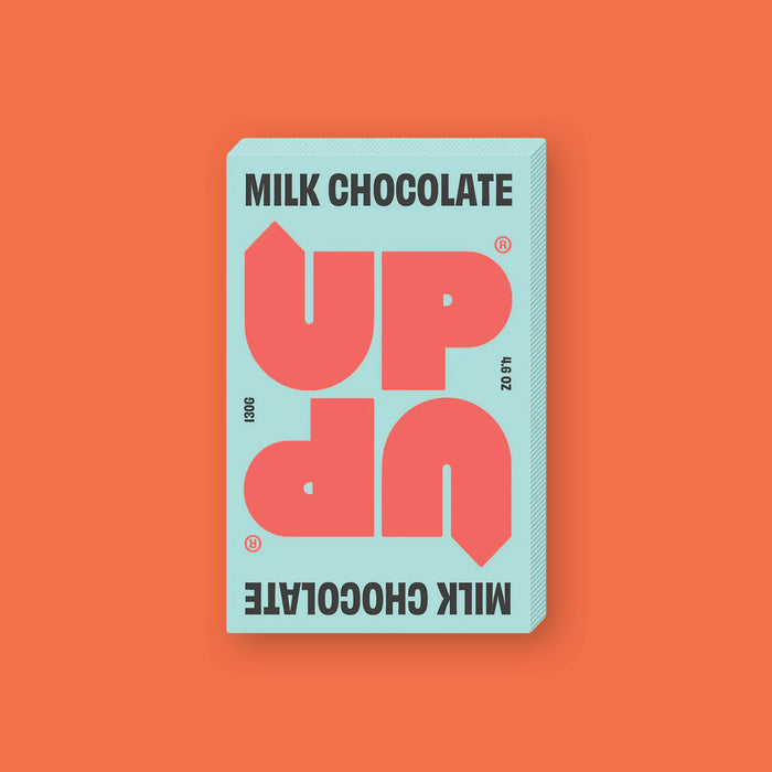 On a orangey-red background sits a box of UP UP Milk Chocolate. The packaging is in mint green and orangey-red.