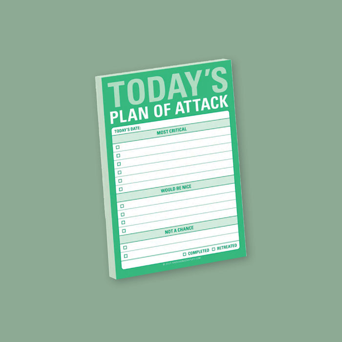 On a moss green background sits a sticky notepad. This big sticky notepad is kelly green with white block on the front. It says in a mint green and white "TODAY'S PLAN OF ATTACK" in all caps block font. There are check boxes and lines and it says "TODAY'S DATE:," "MOST CRITICAL," "WOULD BE NICE," "NOT A CHANCE," and two check boxes and wording that says "COMPLETED" and "RETREATED" in kelly green, all caps block font.