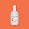 On an orangey-red background sits a bottle. This white bottle has a natural color top and white label. It says "BRIGHTLAND" in black, all caps block font and "LA_California Made" in black, block font. It says "AWAKE" in black, all caps block font inside an orangey-red rectangle and "100% EXTRA VIRGIN OLIVE_OIL FOR COZY DAYS AND SLOW NIGHTS" in black, all caps block font. It has two half circle outlines in orangey-red and pale pink. It also has two blocks in pale pink and mustard yellow. 12.7 oz 375 ml