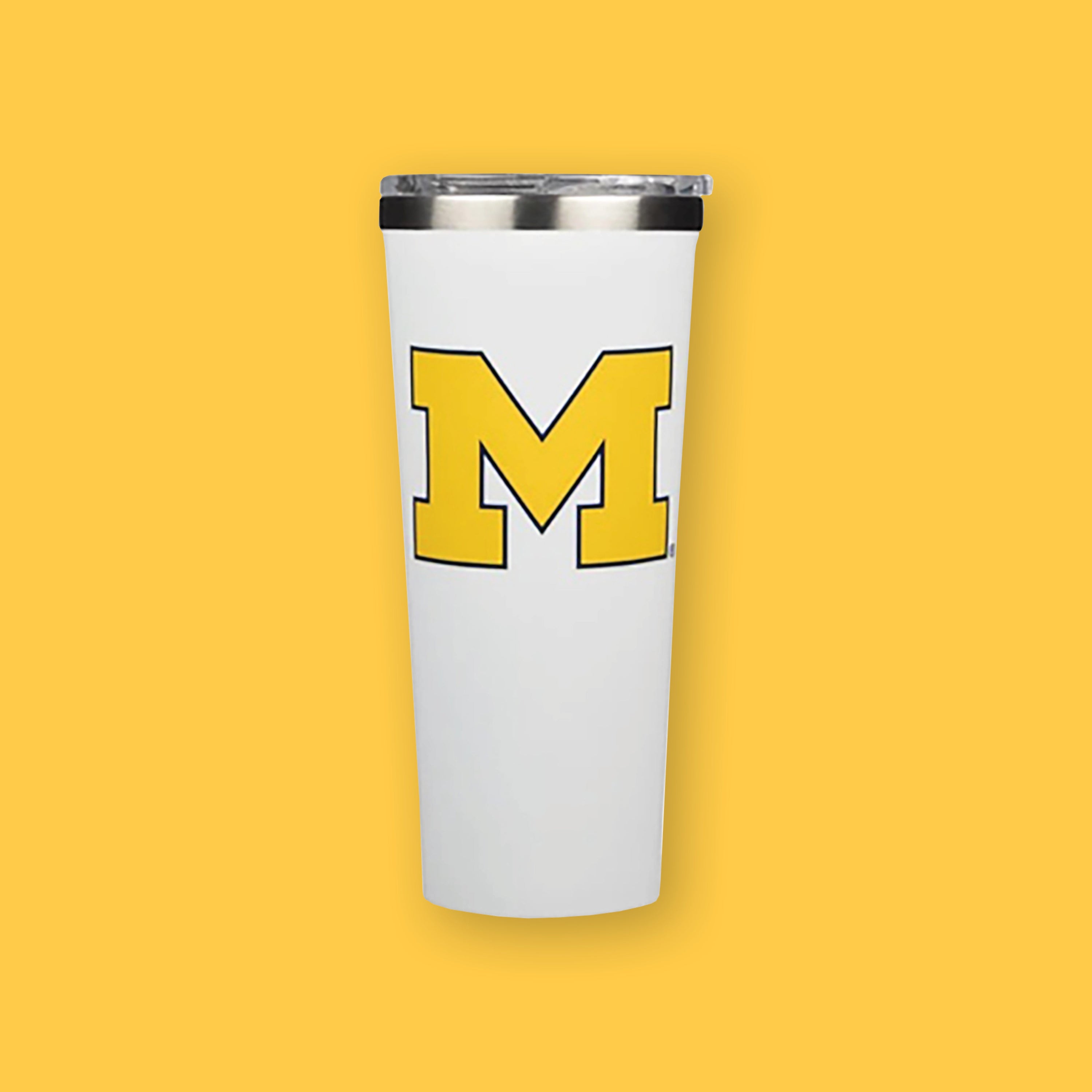 On a sunny mustard background sits a white Corkcicle Michigan Wolverines tumbler. It has a yellow and blue collegiate letter "M" on the front. 24oz