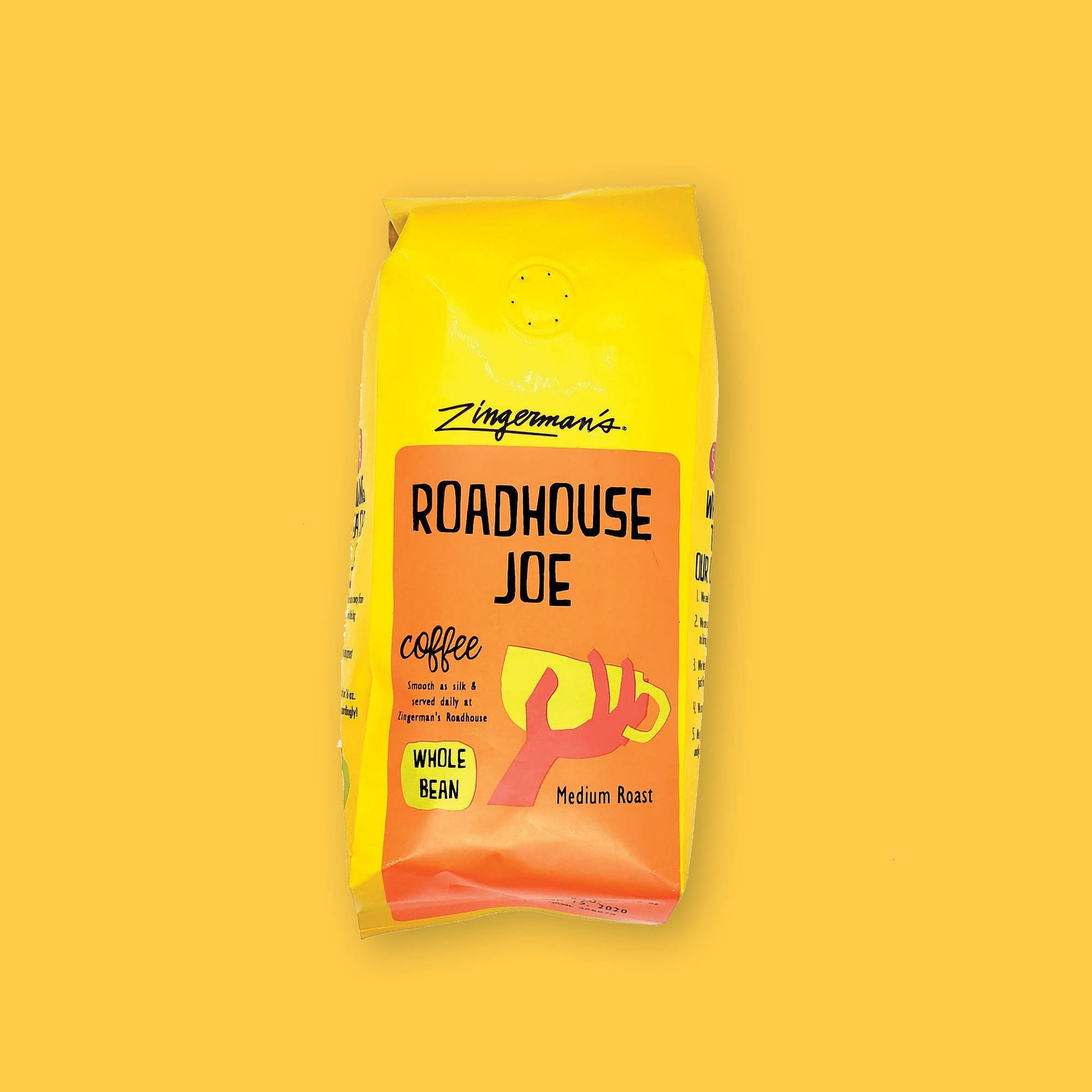 On a sunny mustard background is a yellow bag of coffee. The coffee is Zingerman's brand Roadhouse Joe Blend. 'Smooth as silk and served daily at Zingerman's Roadhouse' Ground coffee. 12 oz (350 g)