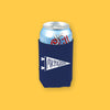 On a sunny mustard background sits a koozie. The navy koozie has a white handdrawn illustration of a pennant with handdrawn lettering that says "Michigan." There is a can inside the koozie.