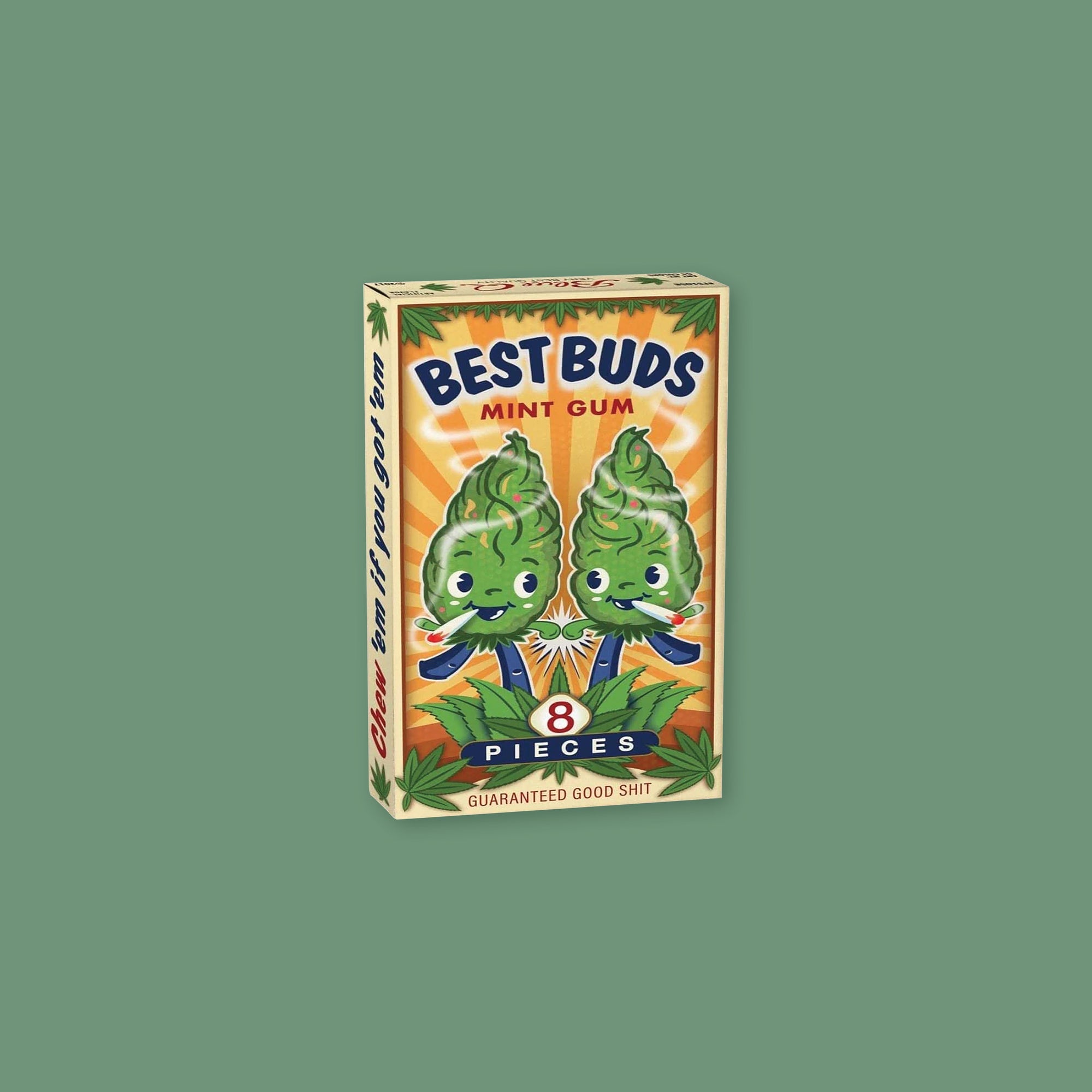 On a mossy green background sits a colorful package of Best Buds Mint Gum. It has an illustration of two "buds" friends smoking marijuana with marijana leaves around the package. I says "GUARANTEED GOOD SHIT" in red, all caps block font. On the side it says "Chew 'em if you got 'em." 8 pieces. 