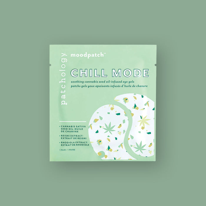 On a moss green background sits a square mint colored package. It has an illustration of two eye gels in white wiht mint, green, and gold leaves and shapes. It says "patchology moodpatch" in white font. It also says "CHILL MODE" in white, all caps block font with green outline. It is 'soothing cannabis seed oil-infused eye gels' and it says "CANNABIS SATIVA SEE OIL," "REISHI EXTXRACT" and "RHODIOLA EXTRACT" in green, all caps block font. 1 pair