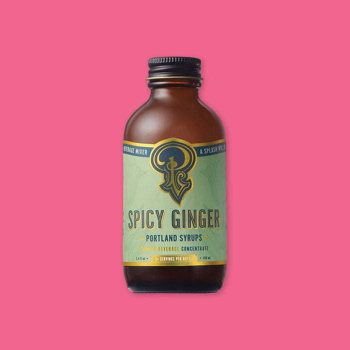 On a hot pink background sits a bottle. This brown glass bottle has a black lid and a mint green label on the front. It says "SPICY GINGER" in navyand gold, all caps block font. Under that says "PORTLAND SYRUPS" and "PREMIUM BEVERAGE CONCENTRATED" in navy and gold, all caps block font. 3+ servings per bottle. 3.4 Fl oz 100 mL