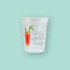 On a mint green background sits a cup. This frosted cup has an illustration of a painted bloody mary with straw, celery, and olives. It says "I drink my vegetables for breakfast." in dark green, handwritten script lettering.