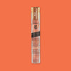 On an orangey-red background sits a clear vintage tube with a cork topper. This YES COCKTAIL CO. tube has a rust label at the top, it says "OLD FASHIONED" in a creamy, all caps block font. It is filled with double oaked Old Fashioned Bitters infused cocktail cubes. NET WT. 32 GRAMS 