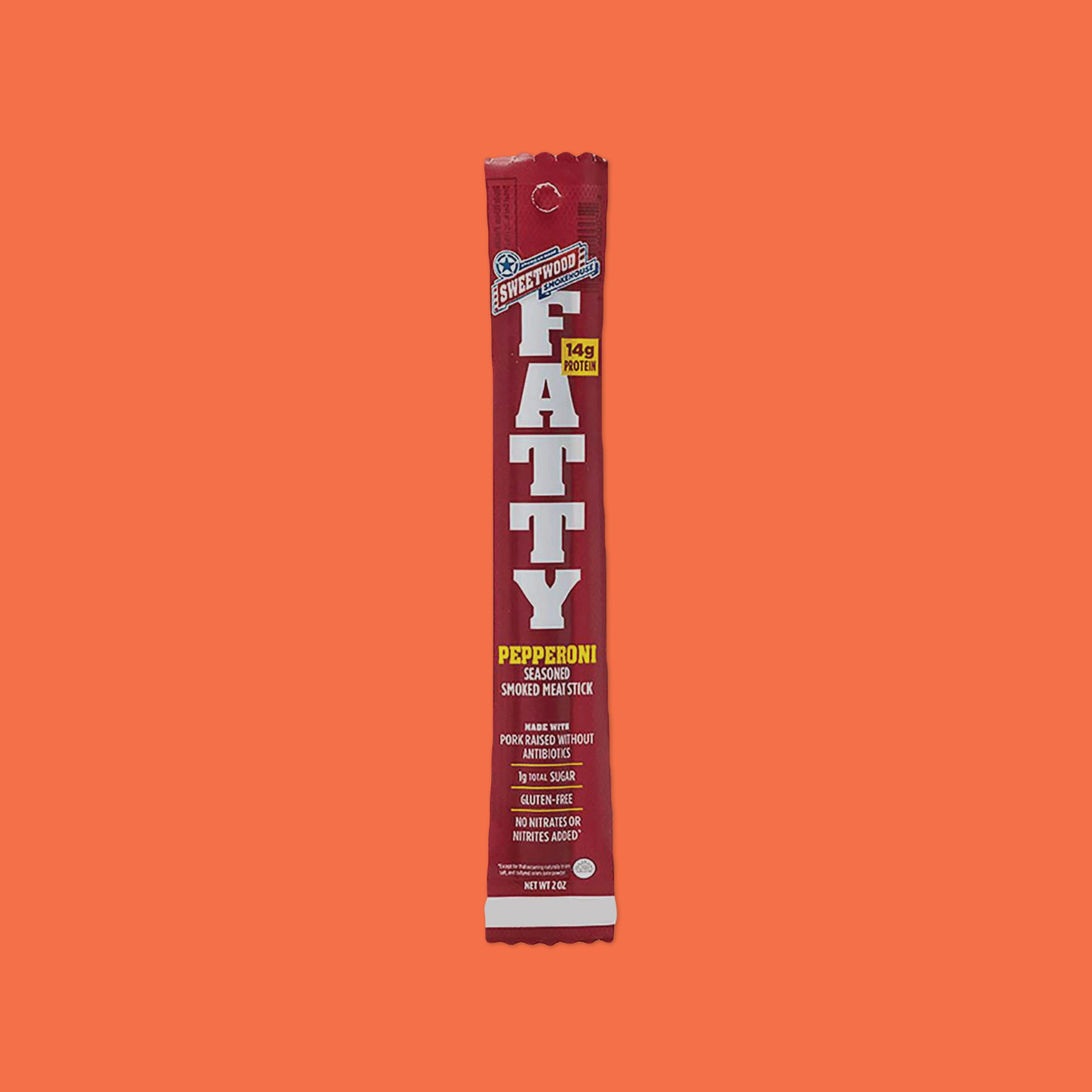 On an orangey-red background sits a maroon package. This package contains a pepperoni seasoned smoked meatstick. It says "FATTY" in white, bold font. It is 'made with pork raised without antibiotics, 1g total sugar, gluten-free, and no nitrates or nitrates added' and it has 14g protein. Net Wt 2 oz