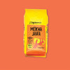 On an orangey-red background sits a coffee package. This yellow package has an orange label on the front. It says "Zingerman's" at the top in black, handwritten lettering. It also says "MOKHA JAVA" in black, handwritten lettering with an illustration of a hand holding a yellow mug. It also says "coffee Dark & earthy with hints of blueberry" in black, handwritten lettering. Whole bean, medium roast 12 oz