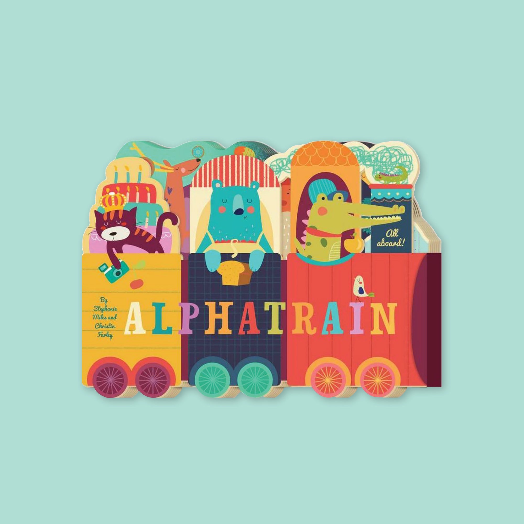 On a mint green background sits a colorful book. This 'ALPHATRAIN' book by Stephanie Miles and Christin Farley shows an illustrated cat holding a camera, a bear wearing an apron and hold a loaf of breat, an alligator wearing a red bandana, and a reindeer in the background. They are all riding on a train and it says "All aboard" in light green, handwritten script lettering.