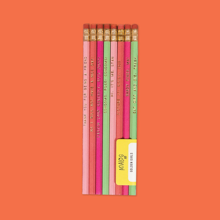 On an orangey-red background sits colorful pencils. This is a close-up of Golden Girls inspired, set of 8 pencils in baby pink, coral, hot pink, and mint. They have various sayings on them. They are "THANK YOUFOR BEING A FRIEND," "NO I WILL NOT HAVE A NICE DAY!," FASTEN YOUR SEATBELT, SLUT PUPPY," "HI, IT'S ME, STAN," "PICTURE IT! SICILY, 1922...," "SHADY PINES, MA!" and 'EAT DIRT AND DIE, TRASH" in gold, all caps block font.