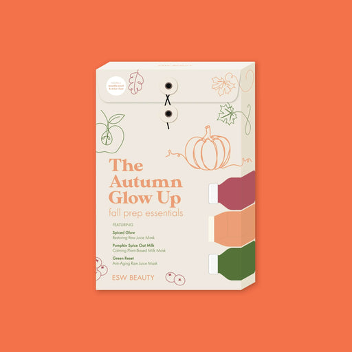 On an orange background sits an ESW BEAUTY box with fall themed line illustrations that says "The Autumn Glow Up: Fall Prep Essentials, Featuring Spiced Glow restoring raw juice mask, Pumpkin Spice Oat Milk calming plant-based milk mask, Green Reset anti-aging raw juice mask. Includes a reusable pouch and sticker sheet!"