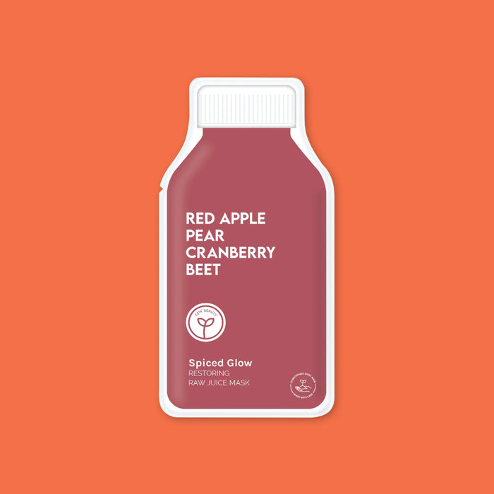On an orange background sits an ESW Beauty single-use face mask in burgandy packaging titled "Red Apple Pear Cranberry Beet Spiced Glow Restoring Raw Juice Mask"