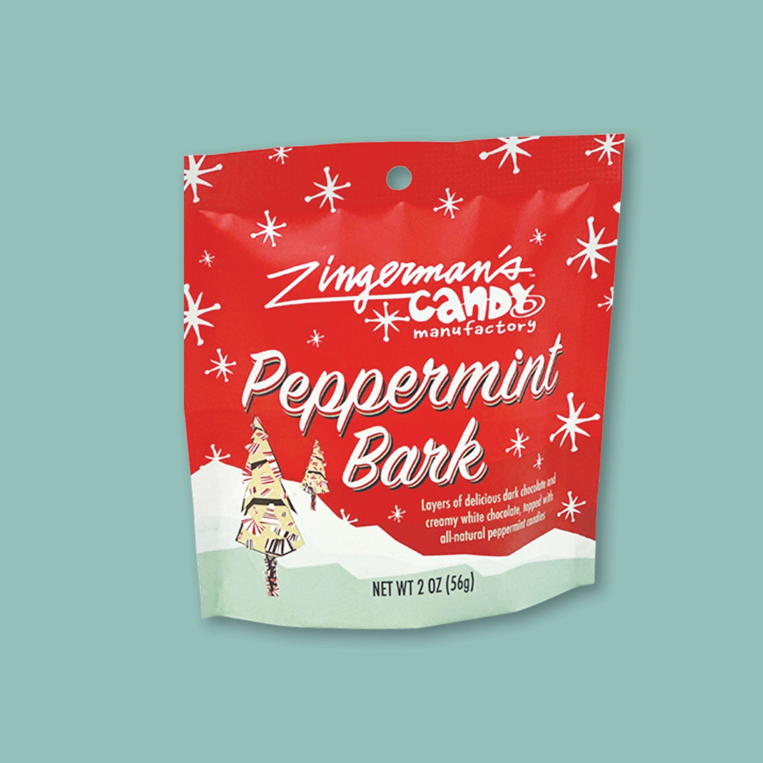 On a sage green background sits a package. This package is red, white, and light green with white snowflakes and two colorful trees. It has white lettering that says "Zingerman's Candy Manufactory" and "Peppermint Bark." NET WT 2 OZ (56G)