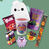 On a green background sits an assortment of kid's gift box items, including plush toys, games, fidgets, snacks and STEM toys -- all in a Halloween theme.