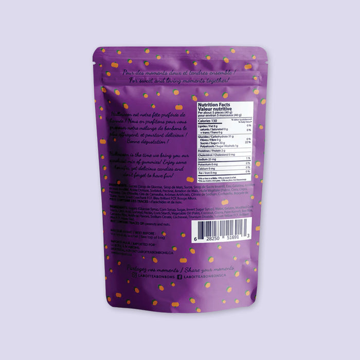 On a lavender background sits a bag of C'est Bon Bon artisanal gummy candies in a purple Halloween bag, with the back of the bag, including nutrition information, exposed.