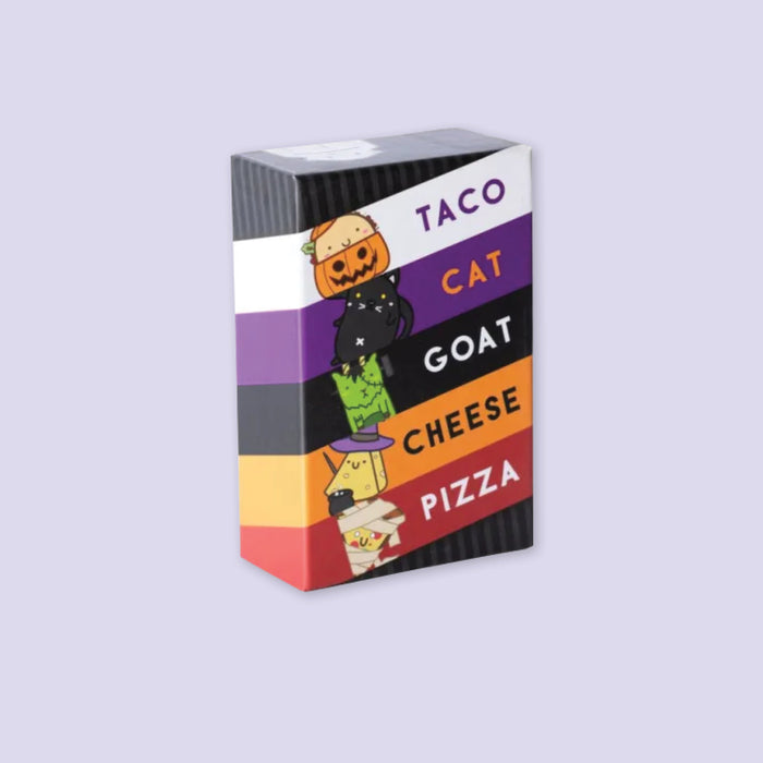 On a lavender background sits the game Taco Cat Goat Cheese Pizza - Halloween Edition!