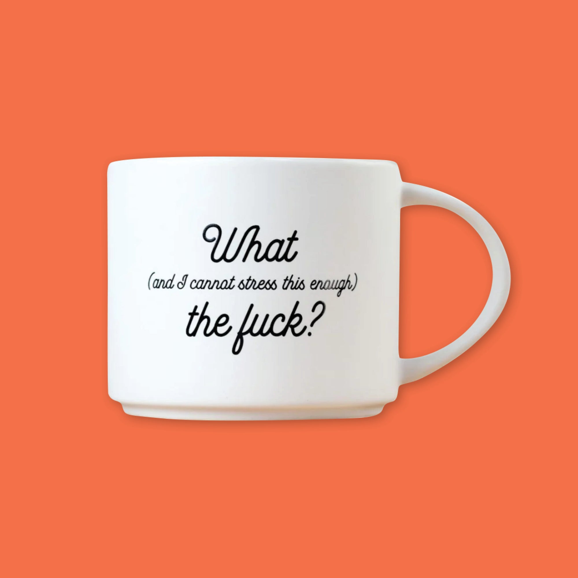 On an orangey red backgound is a photo of a white mug. The mug is a white diner style mug that says in black script, "What (and I cannot stress this enough) the fuck?" 