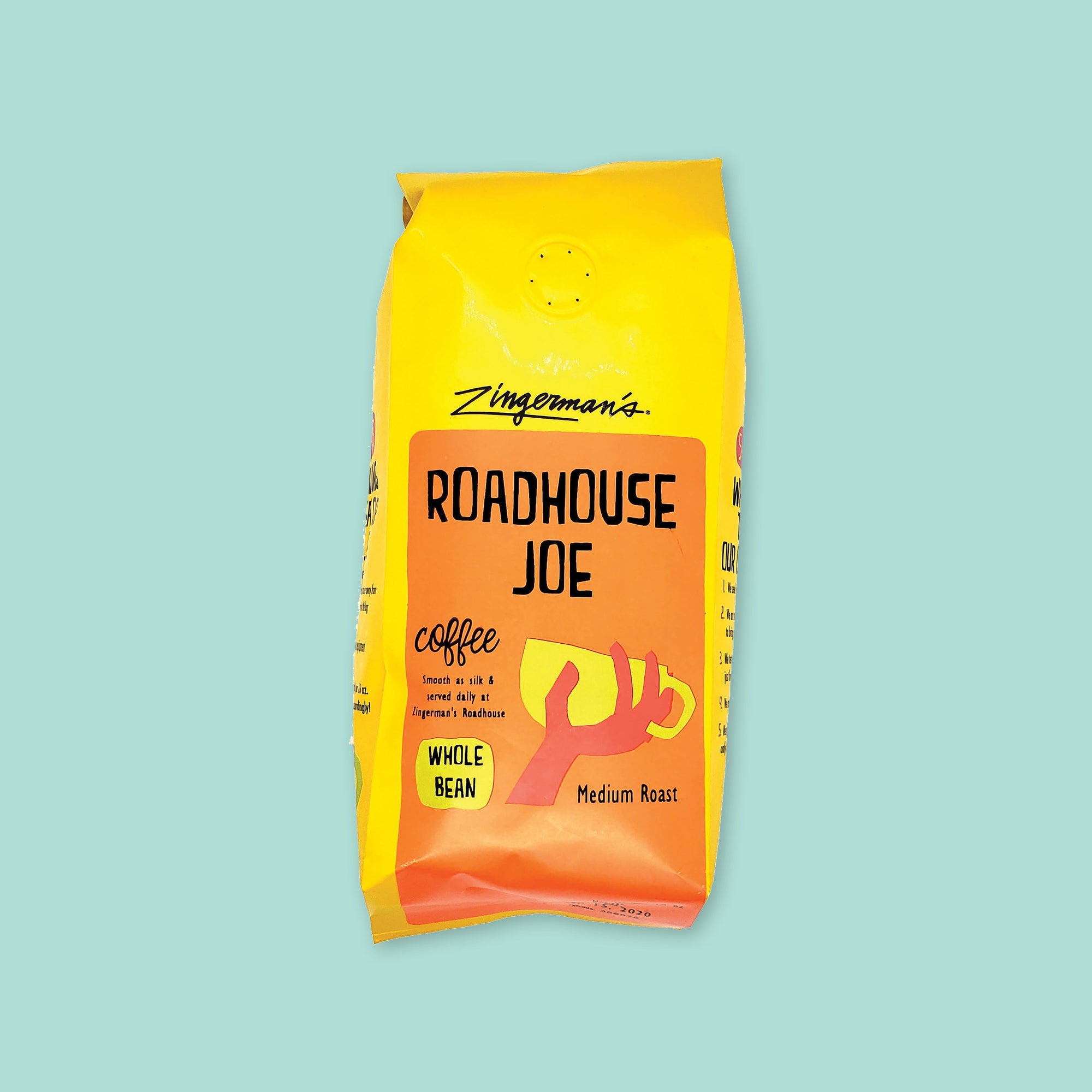 On a cool aqua background is a yellow bag of coffee. The coffee is Zingerman's brand Roadhouse Joe Blend. 'Smooth as silk and served daily at Zingerman's Roadhouse' Ground coffee. 12 oz (350 g)
