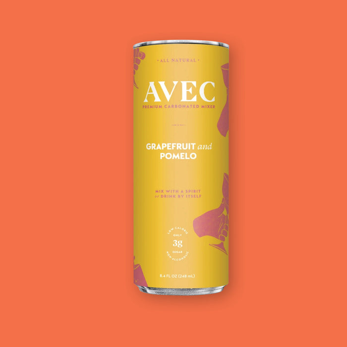 On a coral orange background sits a can of AVEC premium carbonated mixer. This can is mustard yellow and the flavor is Grapefruit and Pomelo. It is all natural and says "Mix With a Spirit or Drink By Itself." It has only 3 grams of sugar and is low calorie. 