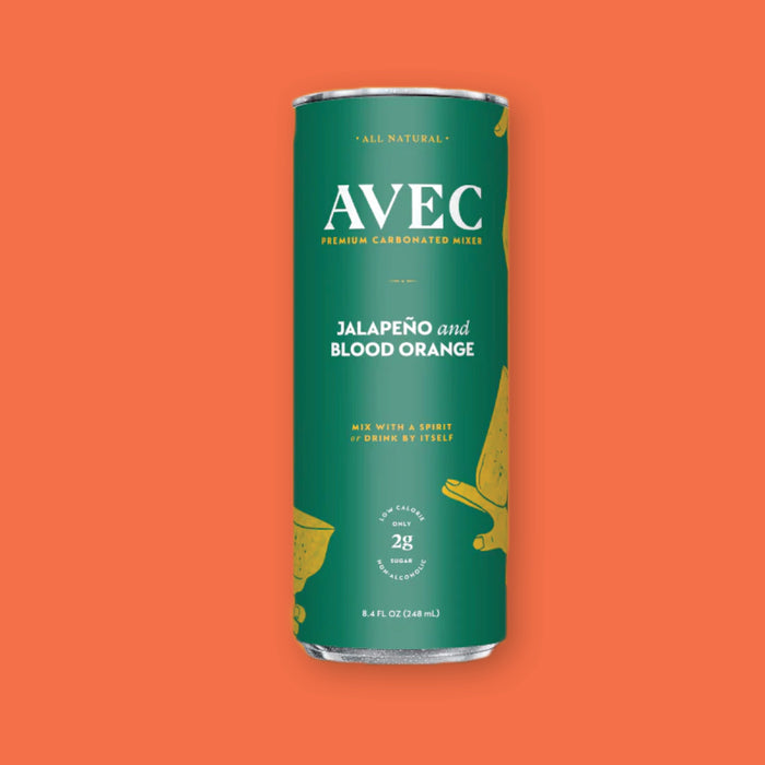 On a coral orange background sits a can of AVEC premium carbonated mixer. This can is green and the flavor is Jalapeno and Blood Orange. It is all natural and says "Mix With a Spirit or Drink By Itself." It has only 2 grams of sugar and is low calorie. 