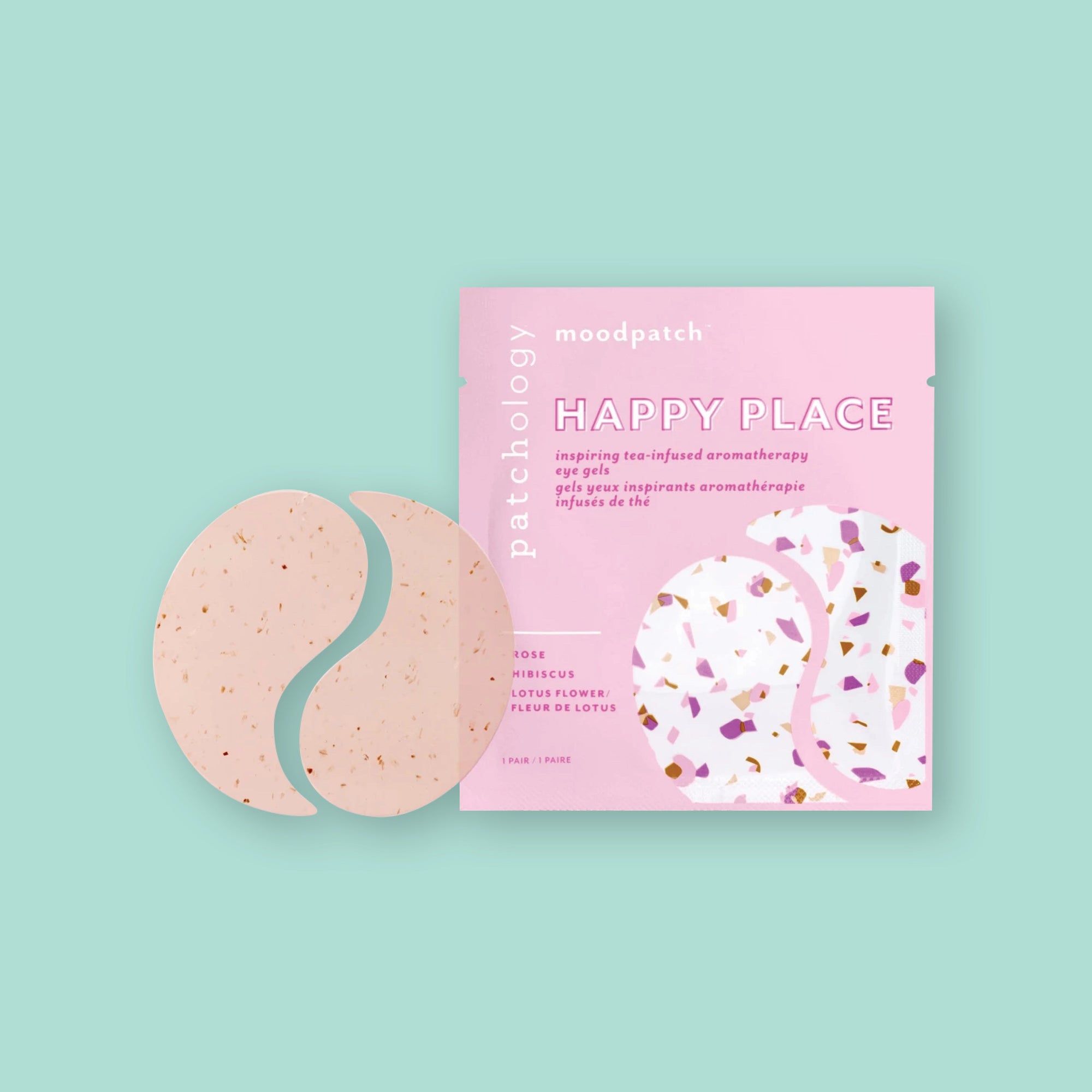 On a seafoam background sits a pink package of Patchology Happy Place Eye Gel Patches. The ingredients are rose, hibiscus, and lotus flower.