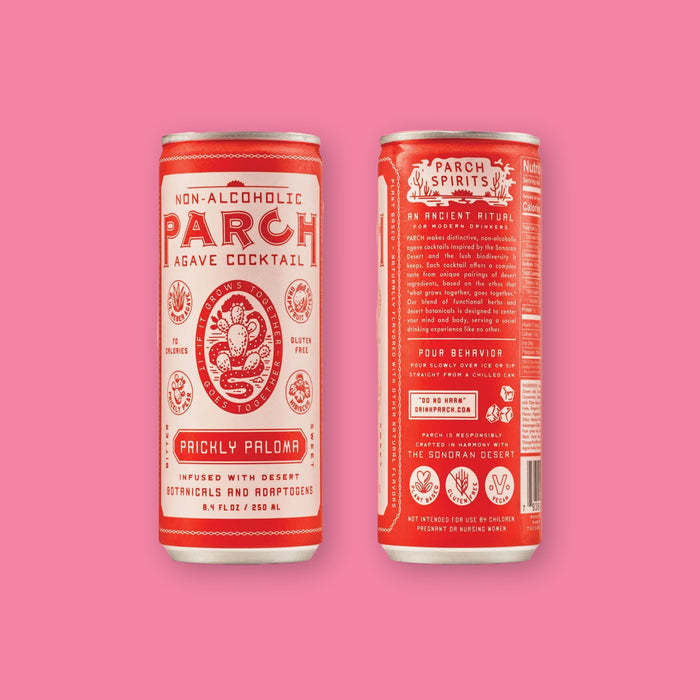 On a bubblegum pink background sits two cream and red cans of the Parch Non-Alcoholic Prickly Paloma Mix. The first can is the front and has an illustration of a cactus and snake on the front in red. The second can is the back. It is infused with desert botanicals and adaptogens, plant based, gluten free and vegan. 8.4 oz (250ml)